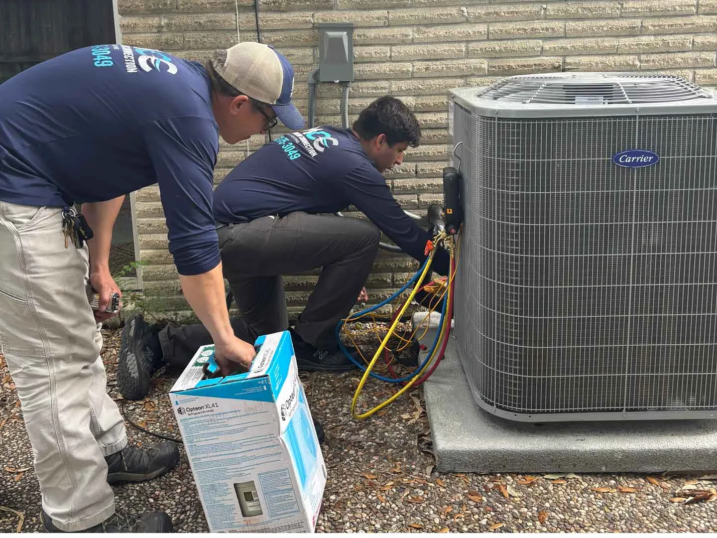 AC maintenance technician servicing unit in Houston TX