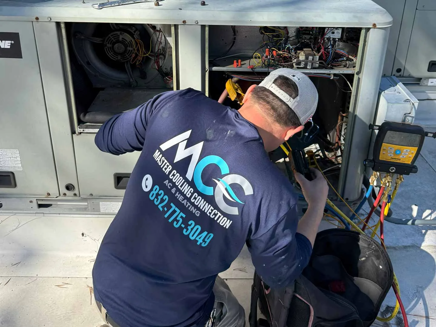 AC repair technician working on outdoor unit in Houston TX